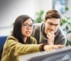 Picture from a man and woman working together in front of a computer