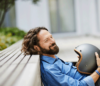 Smiling man with a helmet in his hands
